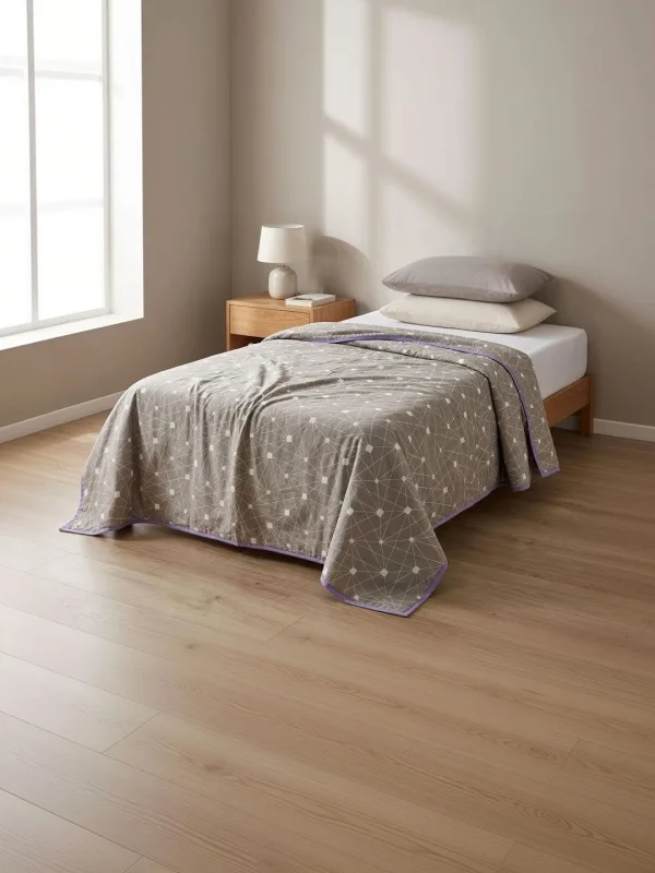 Grey Geometric Constellation 300 GSM cotton single bed blanket in grey, styled on a single bed