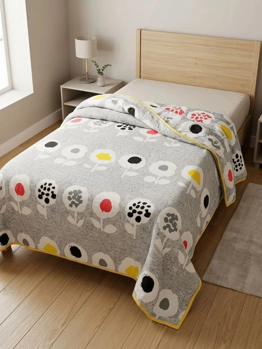 Grey Retro Poppy 300 GSM cotton single bed quilt in grey multicolour, styled on a single bed