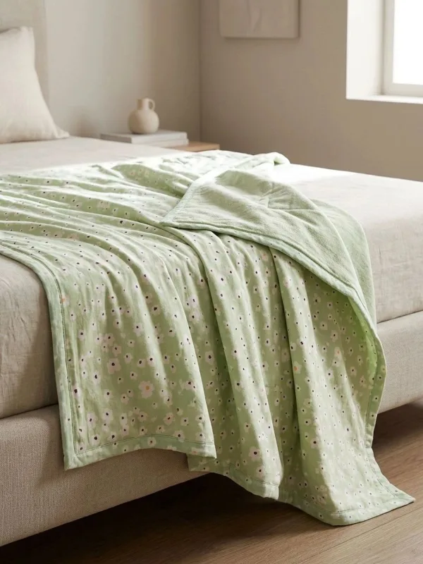 Pistachio Green Ditsy Floral 300 GSM cotton single bed quilt in pistachio green, styled on a single bed
