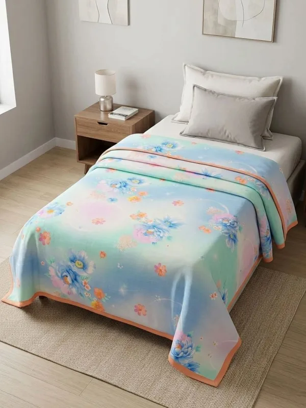 Powder Blue Watercolour Floral 300 GSM cotton single bed quilt in powder blue, styled on a single bed
